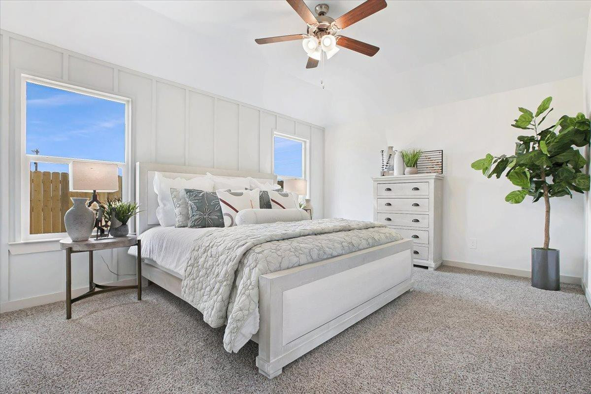 7415 8th Street Lubbock, TX 79416 - Photo 20 of 22 a bedroom with a bed table and a potted plant