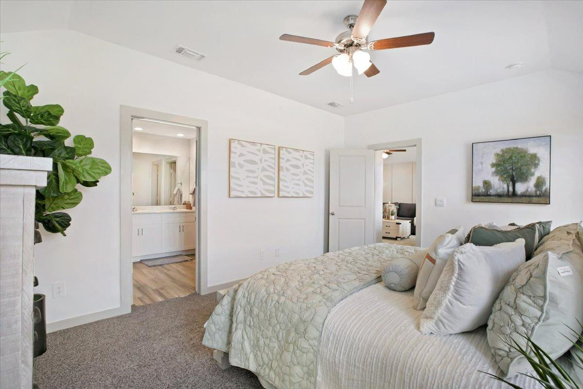 7415 8th Street Lubbock, TX 79416 - Photo 21 of 22 a bedroom with a bed chandelier and a window