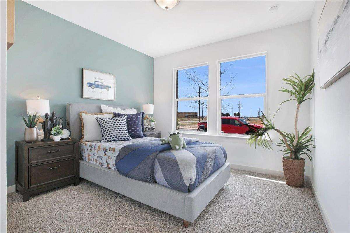 7415 8th Street Lubbock, TX 79416 - Photo 4 of 22 a bed room with a bed and a couch