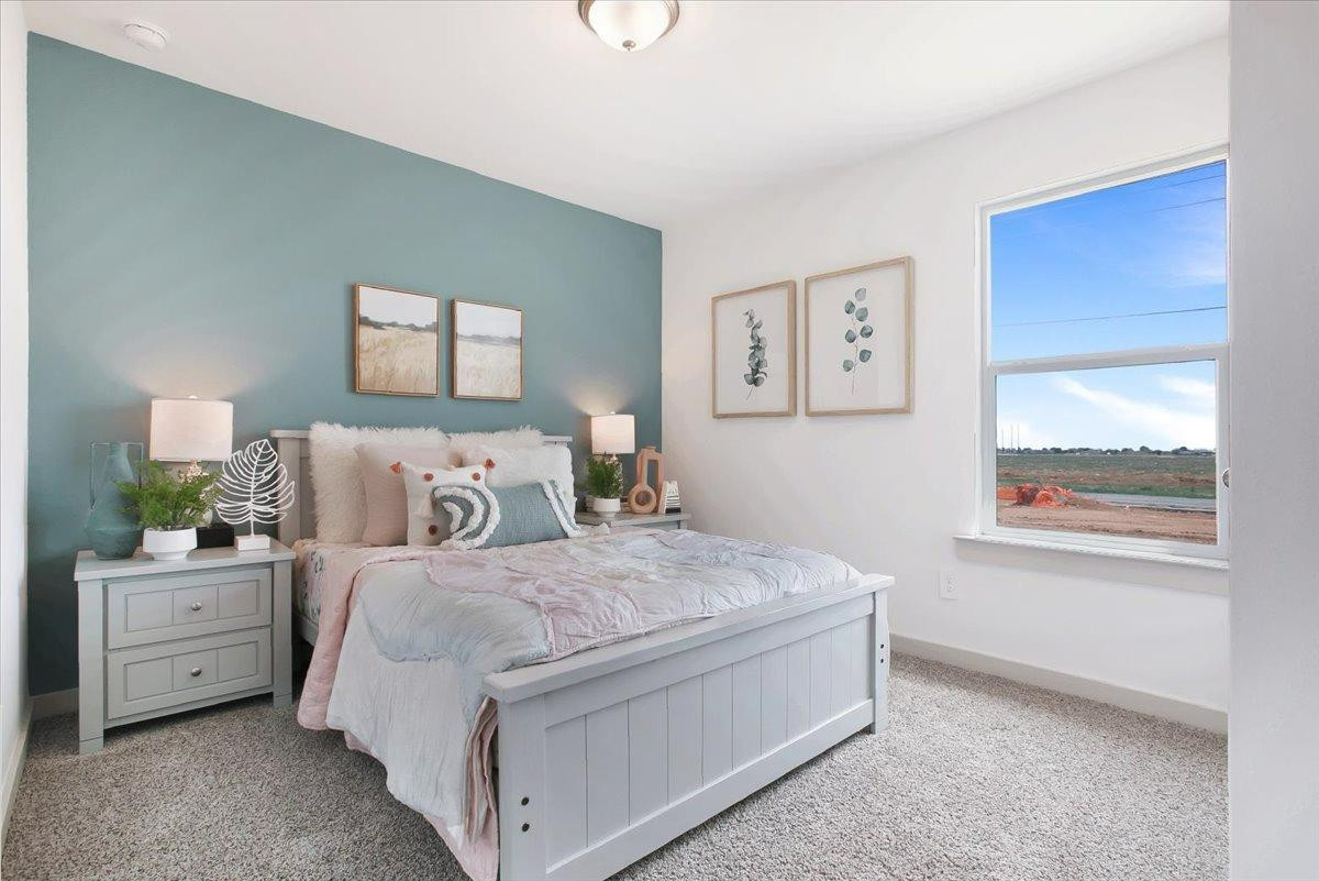 7415 8th Street Lubbock, TX 79416 - Photo 5 of 22 a bedroom with a bed and a window