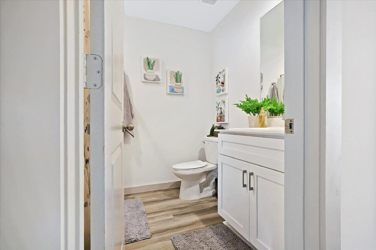 7415 8th Street Lubbock, TX 79416 - Photo 8 of 22 a bathroom with a toilet a sink and vanity