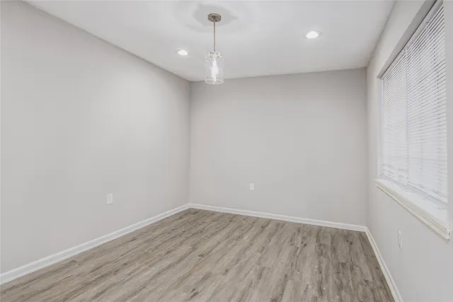 a view of a room with wooden floor and window
