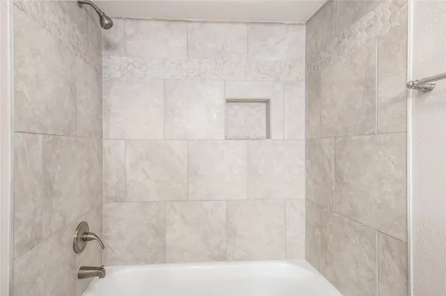 a bathroom with a shower and a sink