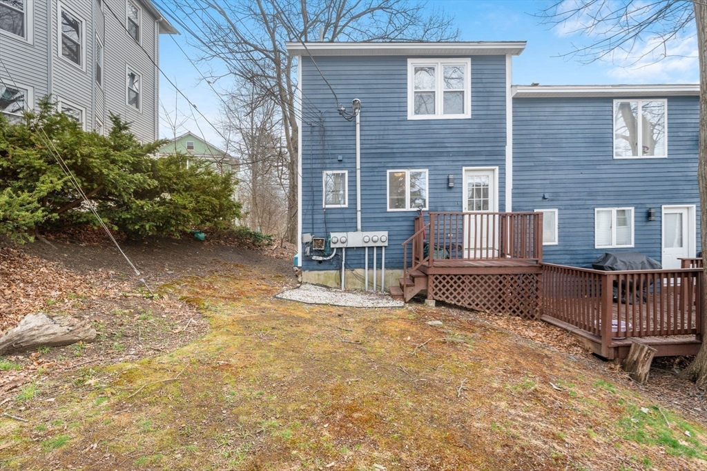 9 Olga Avenue, Unit 9 Worcester, MA 01605 - Photo 20 of 23 a view of backyard with a garden and deck