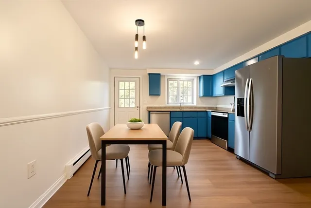 a view of a dining room with furniture and a chandelier