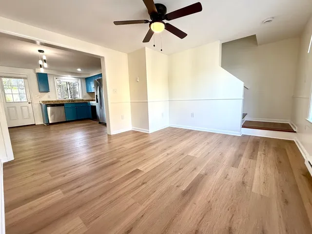 a view of a kitchen with wooden floor and a sink