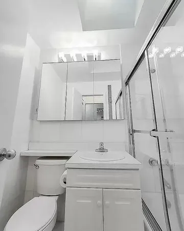 a bathroom with a sink a toilet and mirror