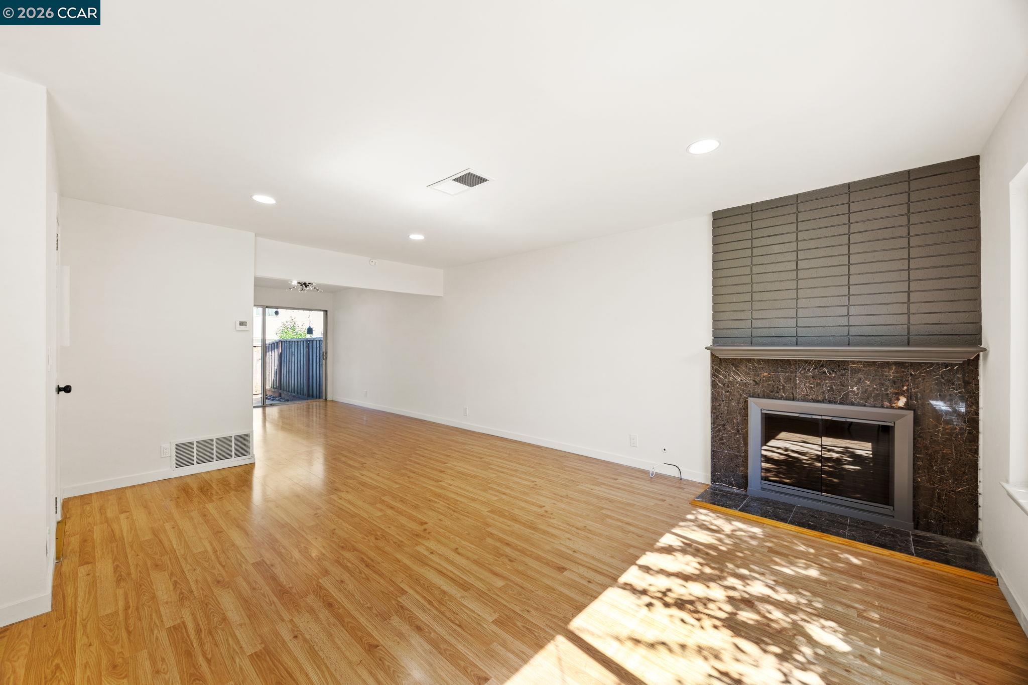 36 Miramonte Drive Moraga, CA 94556 - Photo 12 of 29 a view of empty room with wooden floor and fireplace