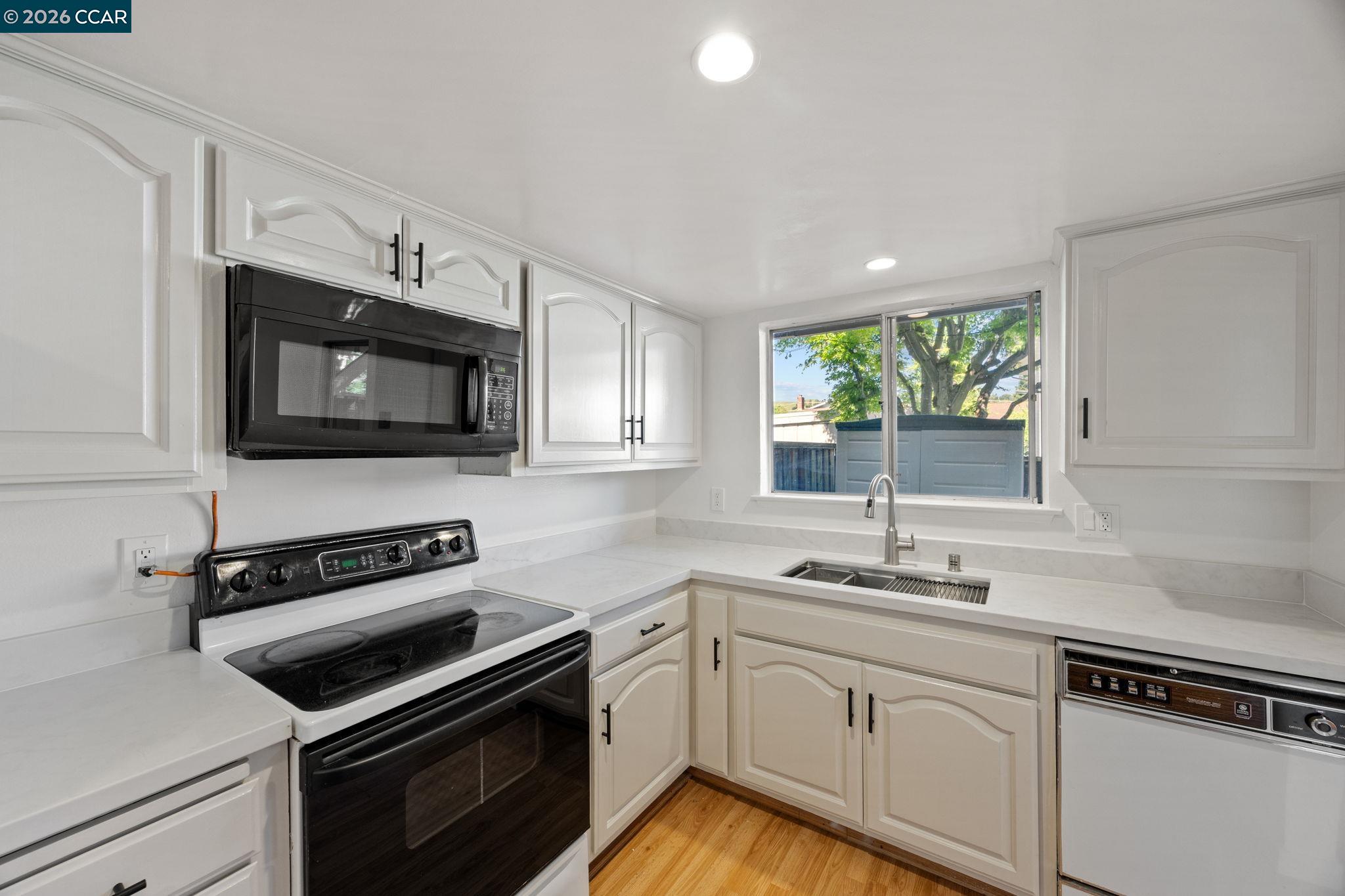 36 Miramonte Drive Moraga, CA 94556 - Photo 14 of 29 a kitchen with white cabinets appliances and a window