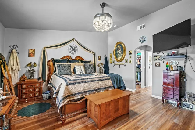 a bathroom with a granite countertop sink a toilet a mirror a vanity and shower