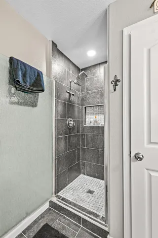 a view of a swimming pool with a yard and wooden fence