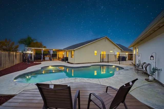 a swimming pool with outdoor seating