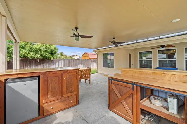 a view of living room with furniture and a floor to ceiling window