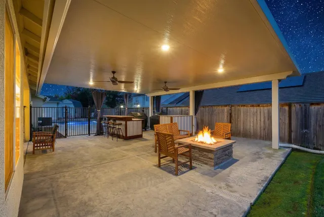 a living room with furniture kitchen and a large window