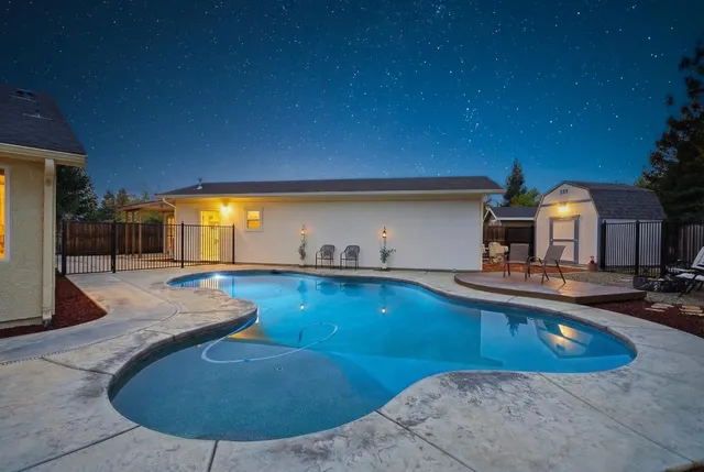 a kitchen with stainless steel appliances granite countertop a stove top oven a sink dishwasher and cabinets with wooden floor