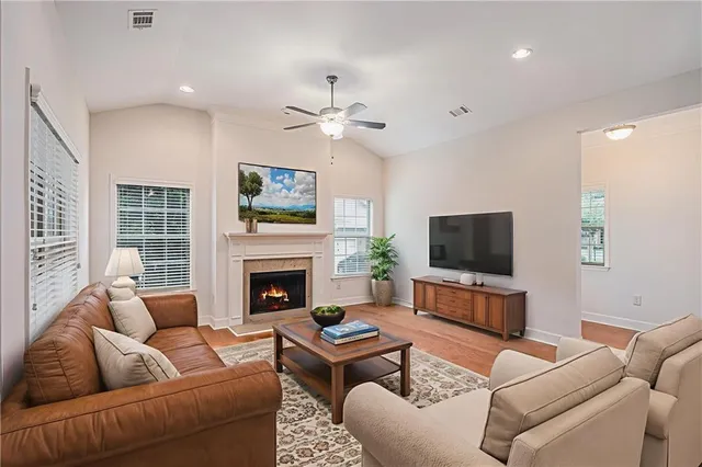 a living room with furniture a fireplace and a flat screen tv