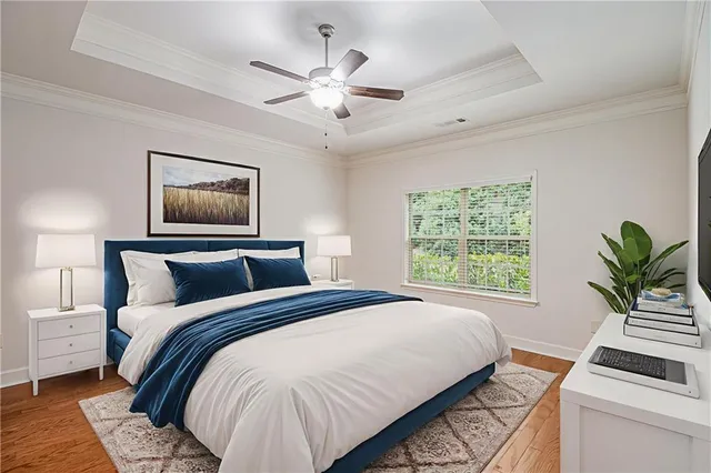 a bedroom with a large bed and a chandelier