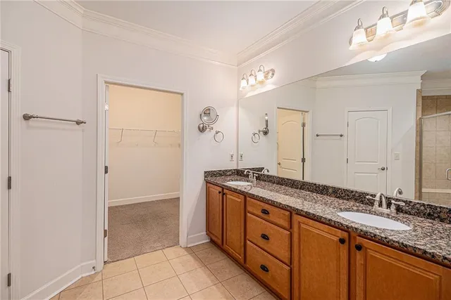 a spacious bathroom with a granite countertop sink a mirror and a