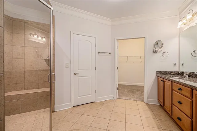 a bathroom with a granite countertop sink a mirror and shower