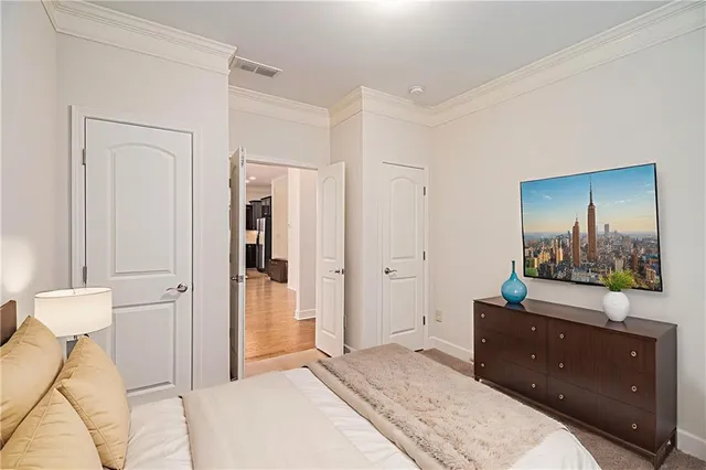 a bedroom with a bed and a dresser