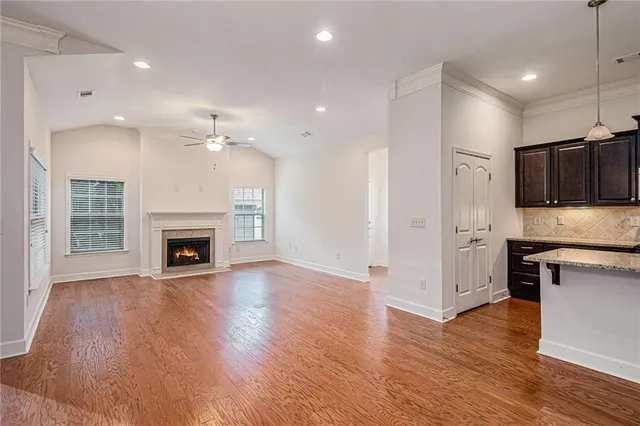 a view of kitchen with granite countertop cabinets and wooden floor