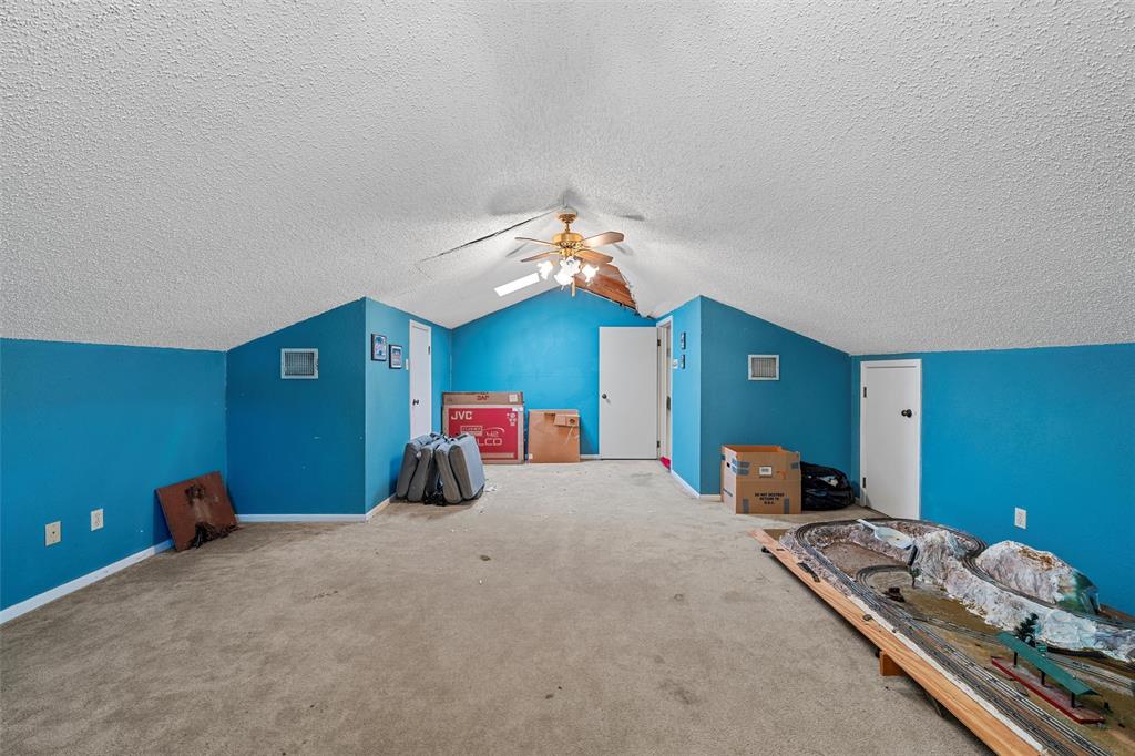 116 Boleman Drive Hewitt, TX 76643 - Photo 17 of 38 Additional living space featuring lofted ceiling, carpet flooring, ceiling fan, and a textured ceiling