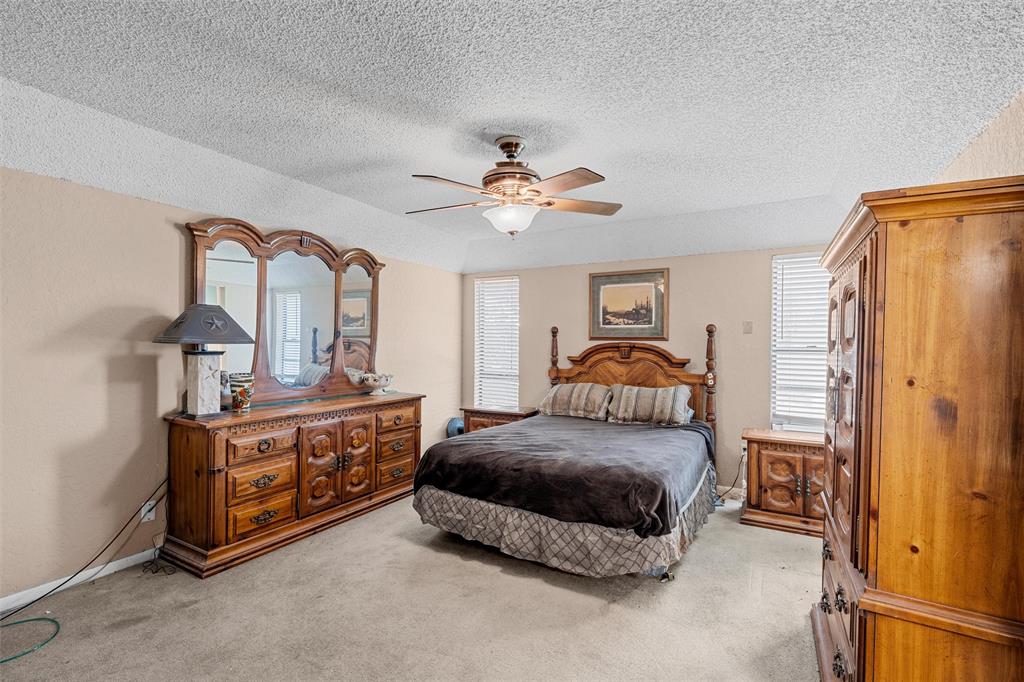 116 Boleman Drive Hewitt, TX 76643 - Photo 23 of 38 Bedroom featuring light colored carpet, a textured ceiling, and ceiling fan