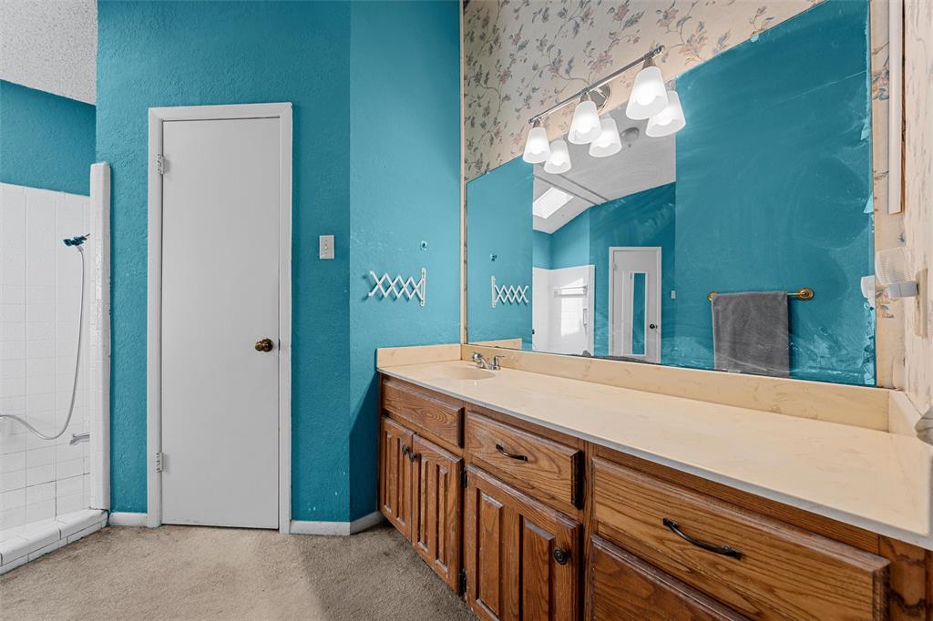 116 Boleman Drive Hewitt, TX 76643 - Photo 25 of 38 Bathroom featuring a textured wall, vanity, and a shower