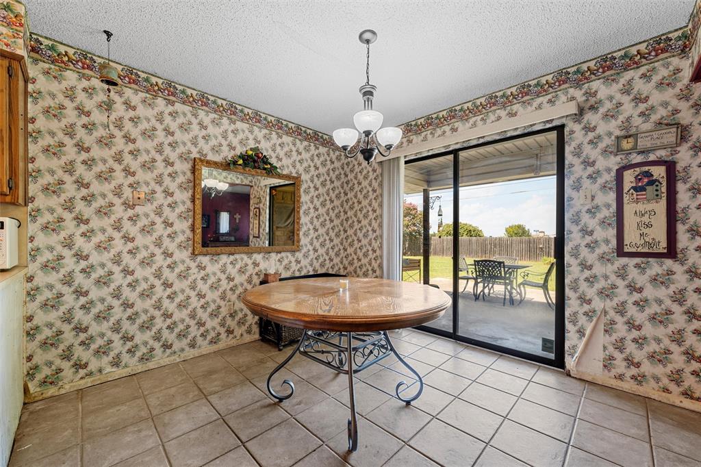116 Boleman Drive Hewitt, TX 76643 - Photo 9 of 38 Dining space featuring light tile patterned flooring, a textured ceiling, and wallpapered walls