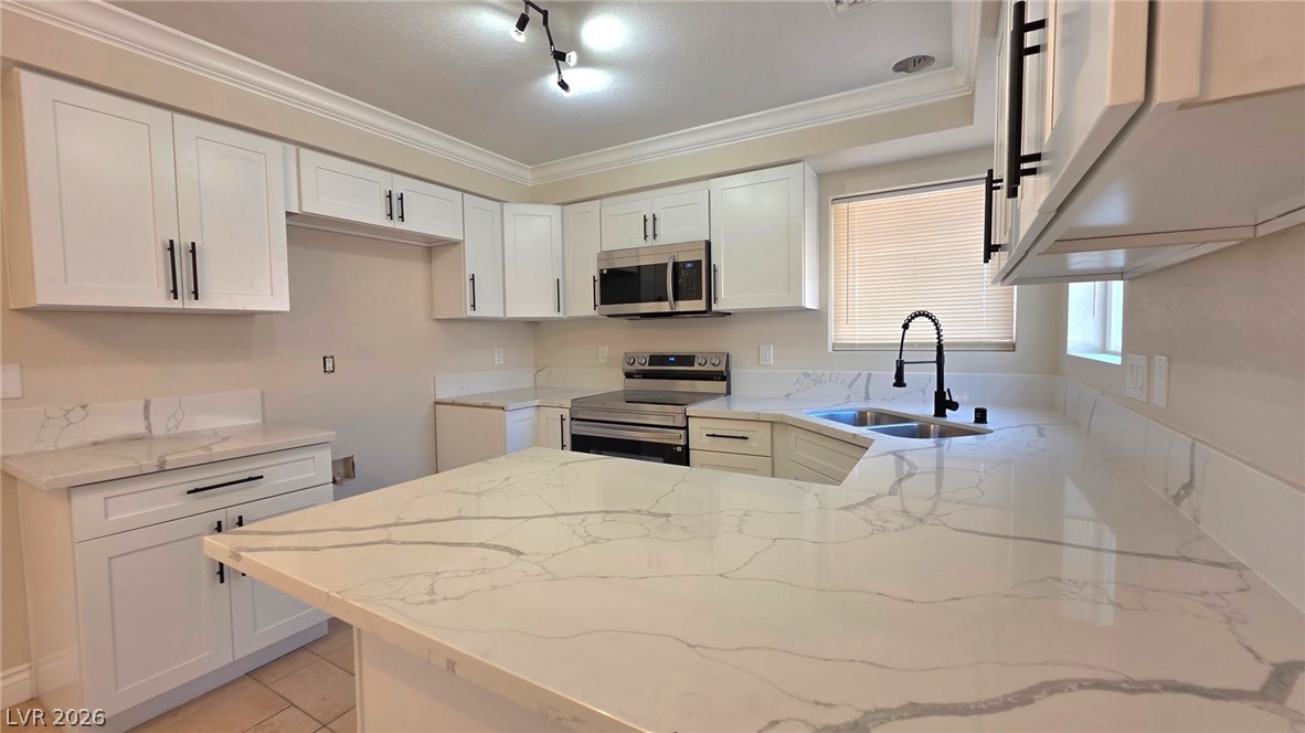 2155 Athol Way Laughlin, NV 89029 - Photo 3 of 19 Culinary delights await in this bright kitchen with pristine counters and modern appliances.