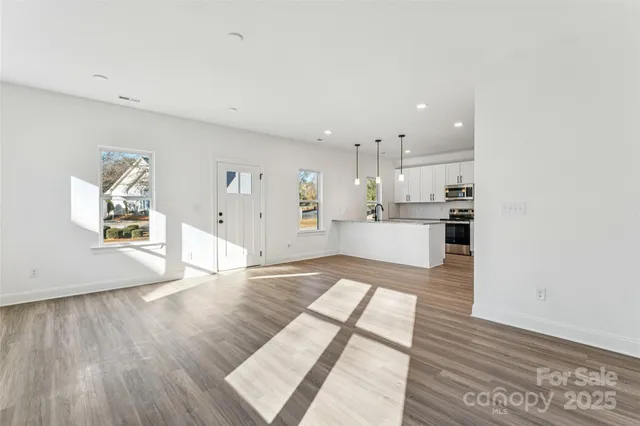 a view of kitchen living room with wooden floor and window
