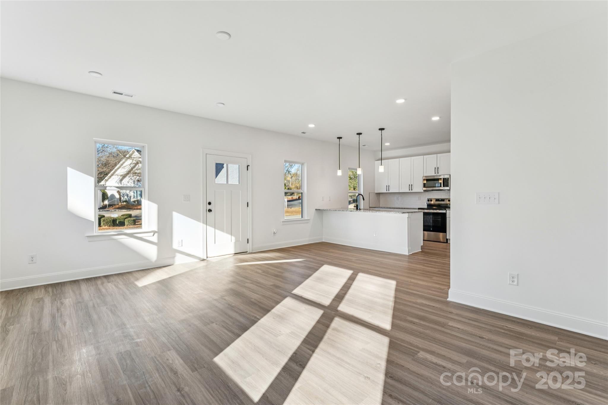 400 South Spargo Street Dallas, NC 28034 - Photo 15 of 26 a view of kitchen living room with wooden floor and window