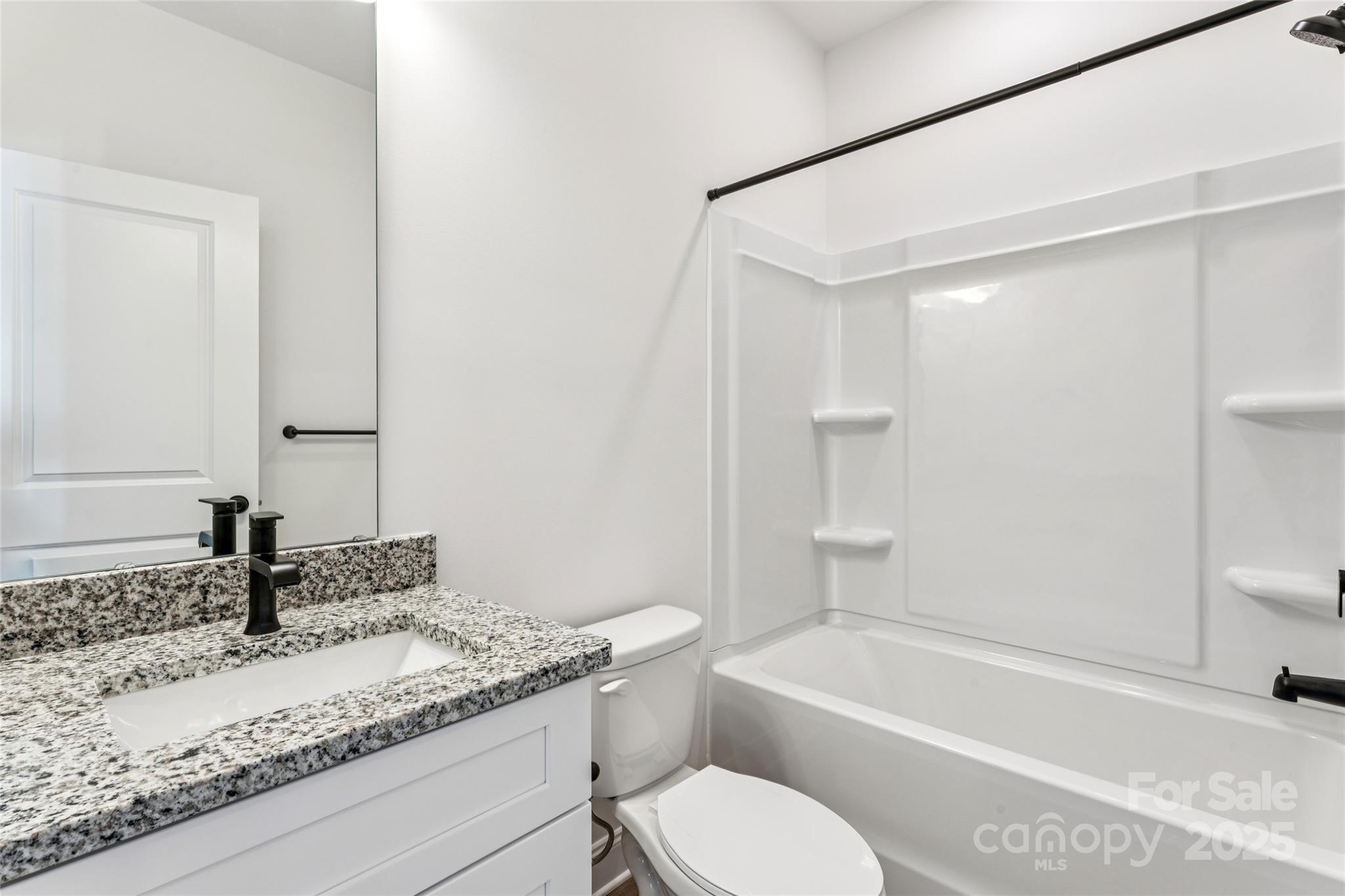 400 South Spargo Street Dallas, NC 28034 - Photo 19 of 26 a bathroom with a granite countertop sink toilet and shower