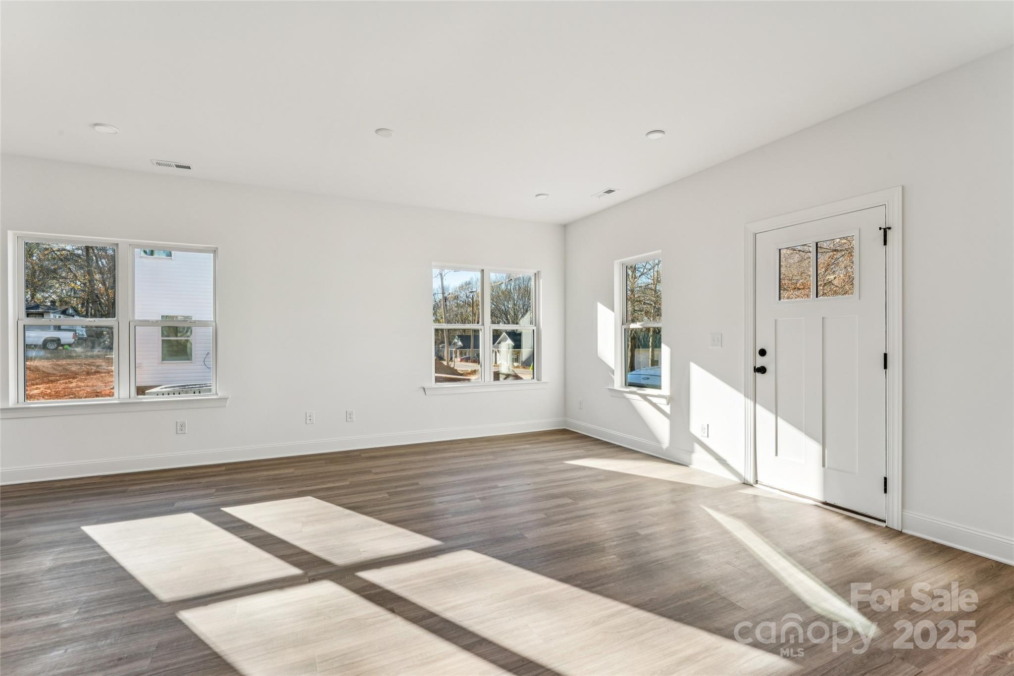 400 South Spargo Street Dallas, NC 28034 - Photo 7 of 26 a view of an empty room with window and wooden floor