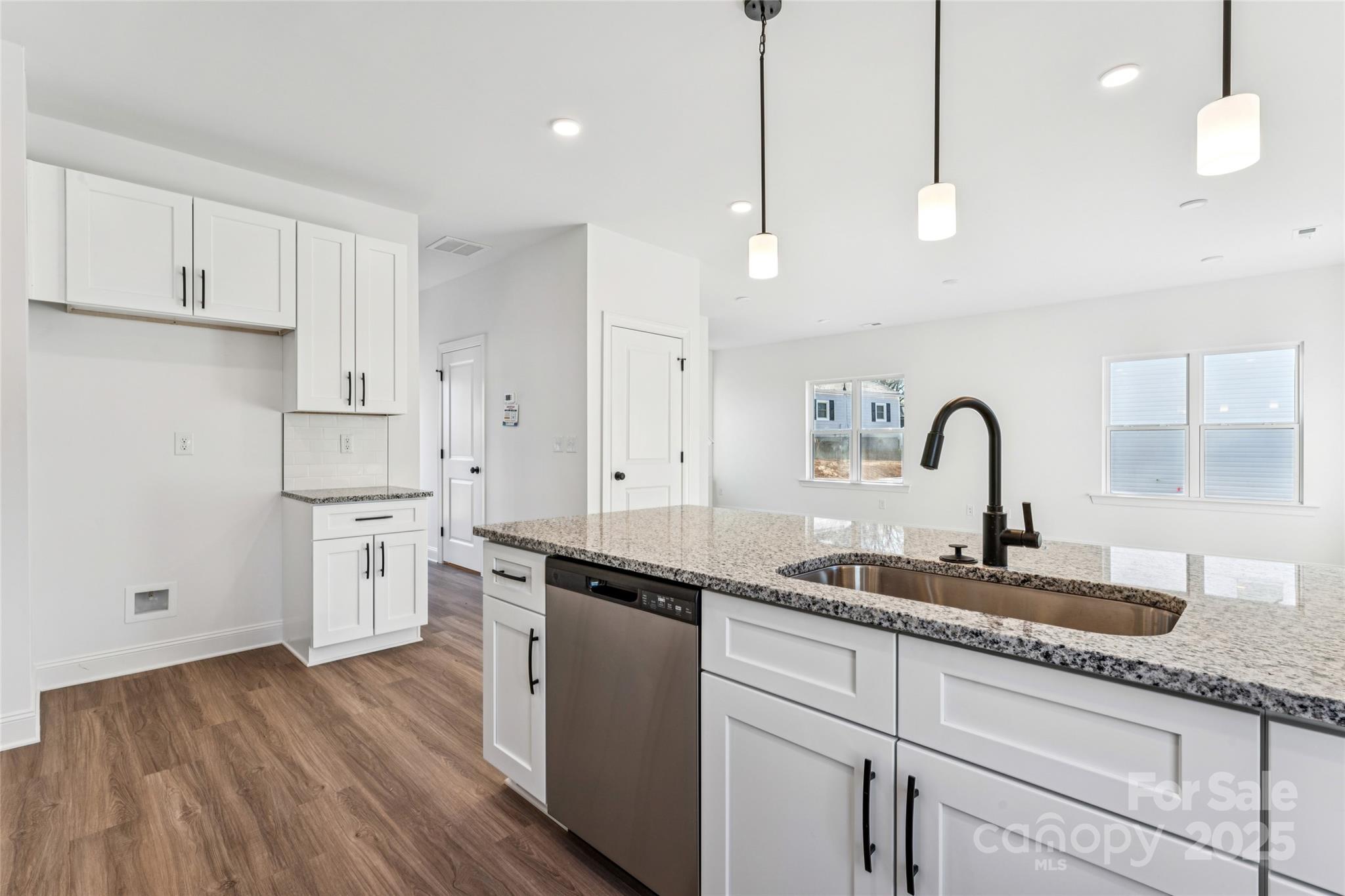 400 South Spargo Street Dallas, NC 28034 - Photo 10 of 26 a kitchen with granite countertop white cabinets and white appliances