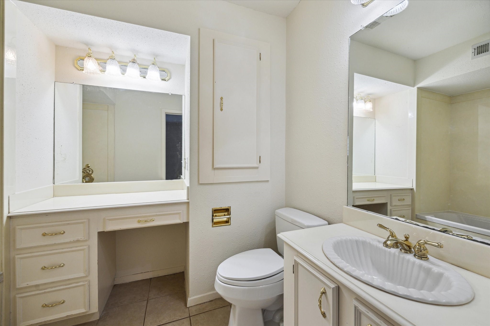 4040 San Felipe Street, Unit 135 Houston, TX 77027 - Photo 15 of 17 a bathroom with a toilet sink and mirror