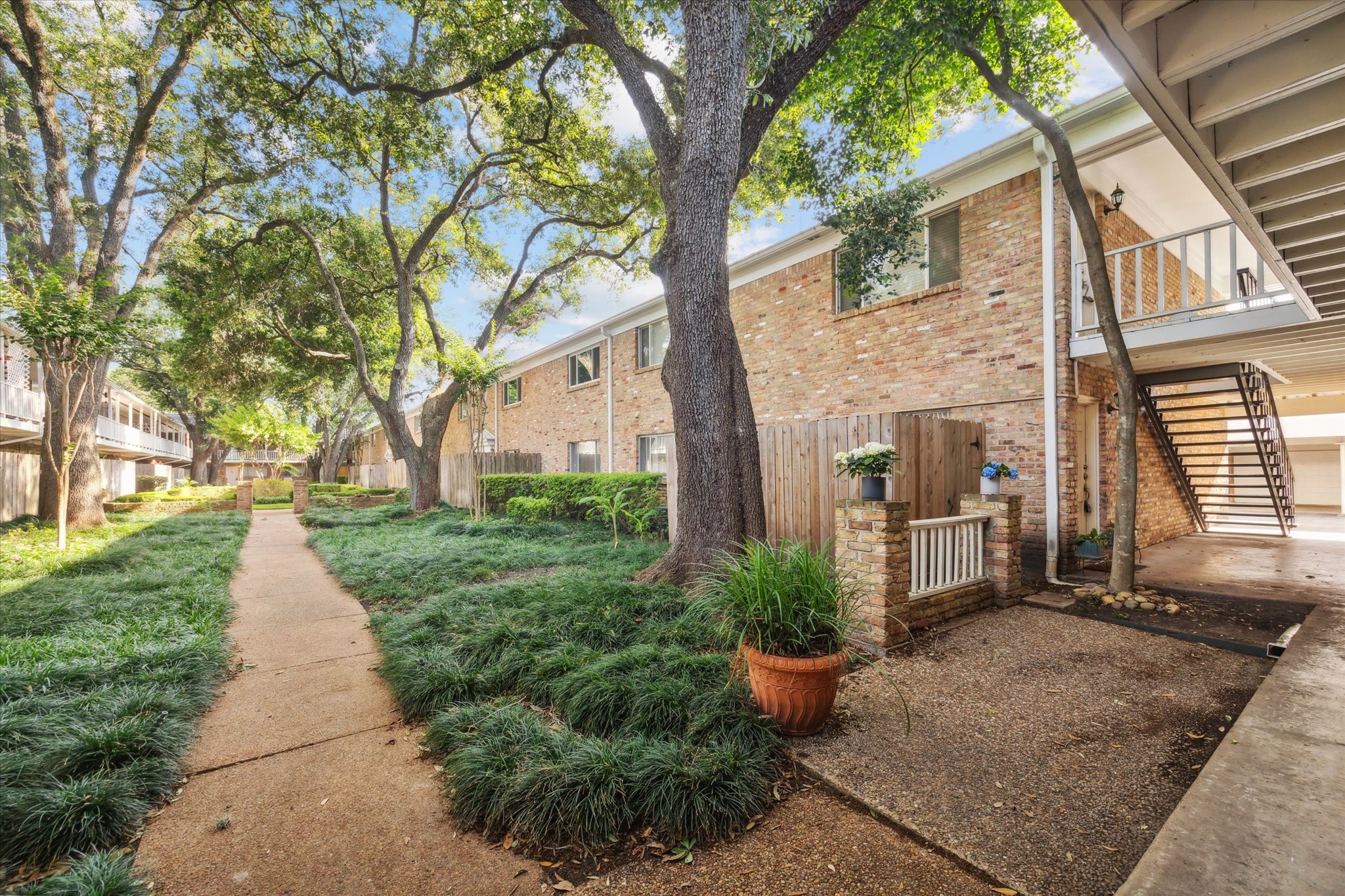 4040 San Felipe Street, Unit 135 Houston, TX 77027 - Photo 2 of 17 a front view of a house with garden and plants