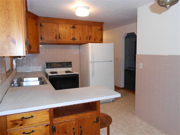 23 Varney Street Springfield, MA 01108 - Photo 4 of 10 a kitchen with stainless steel appliances a refrigerator a sink a stove and white cabinets
