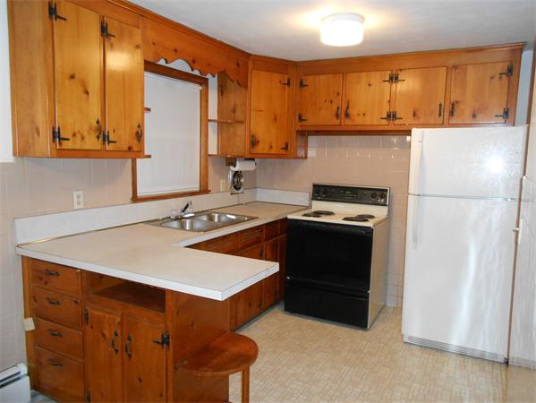 23 Varney Street Springfield, MA 01108 - Photo 5 of 10 a kitchen with a sink a stove and a refrigerator