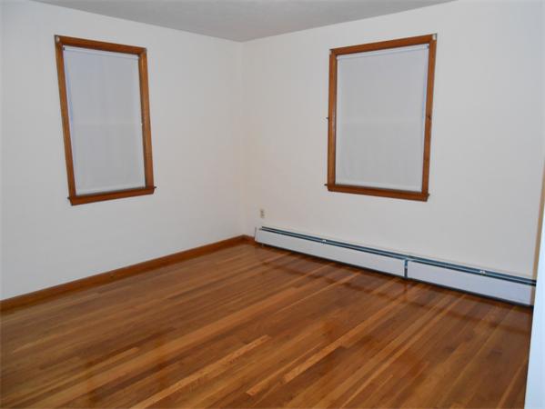 23 Varney Street Springfield, MA 01108 - Photo 9 of 10 a view of an empty room with wooden floor and a window