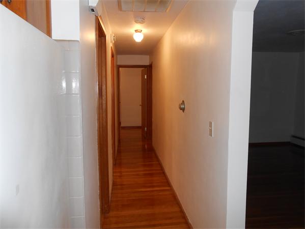 23 Varney Street Springfield, MA 01108 - Photo 10 of 10 a view of a hallway with wooden floor