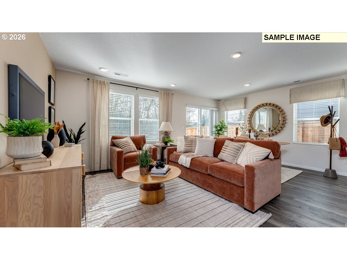 130 Coho Loop Woodland, WA 98674 - Photo 14 of 28 a living room with furniture and a wooden floor