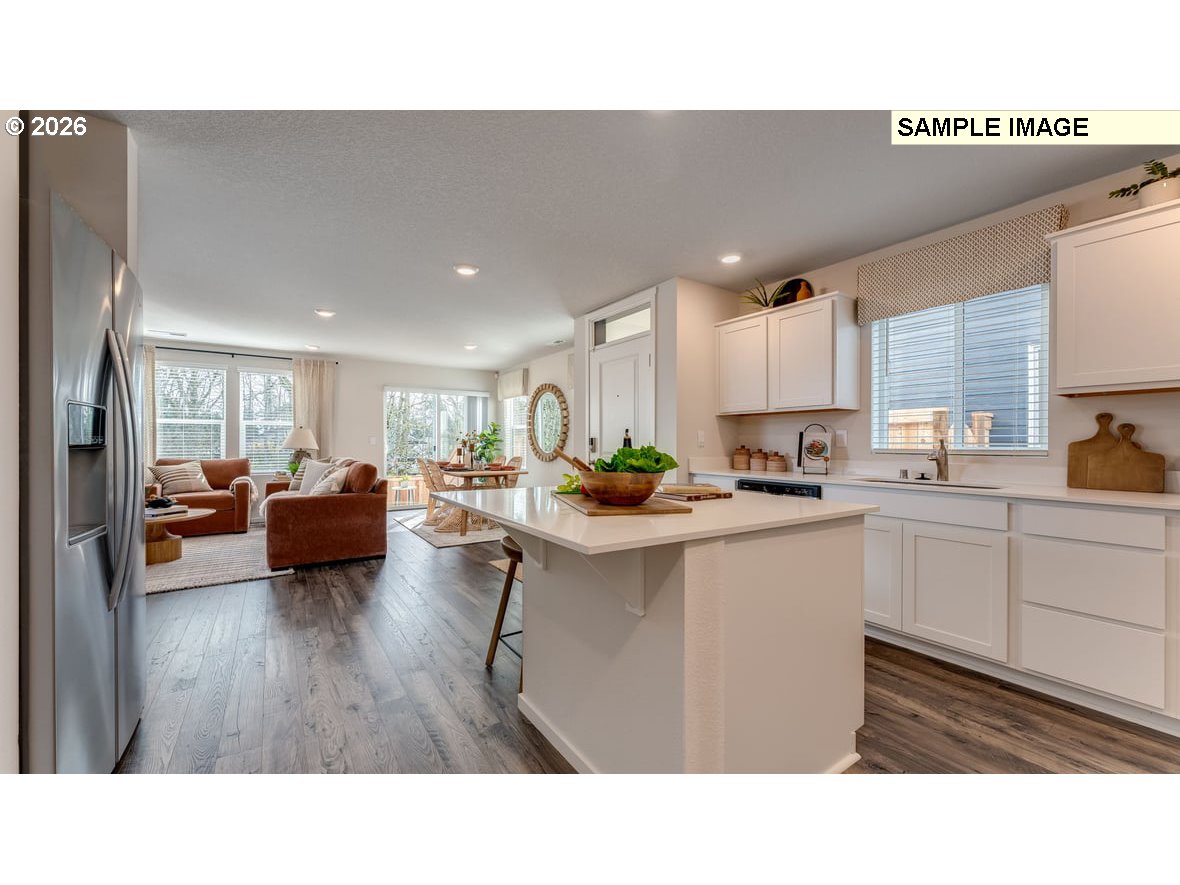 130 Coho Loop Woodland, WA 98674 - Photo 7 of 28 a living room with furniture a rug kitchen view and a chandelier