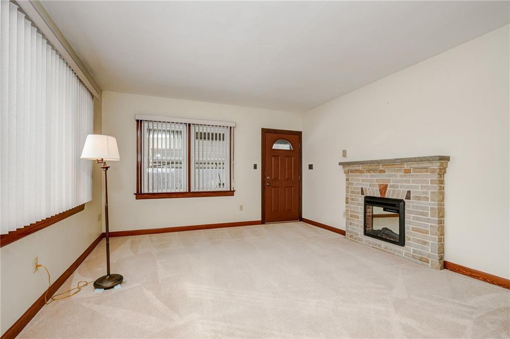 1231 North Main St Extension Butler, PA 16001 - Photo 5 of 15 Spacious living room with lots of windows and stone fireplace.