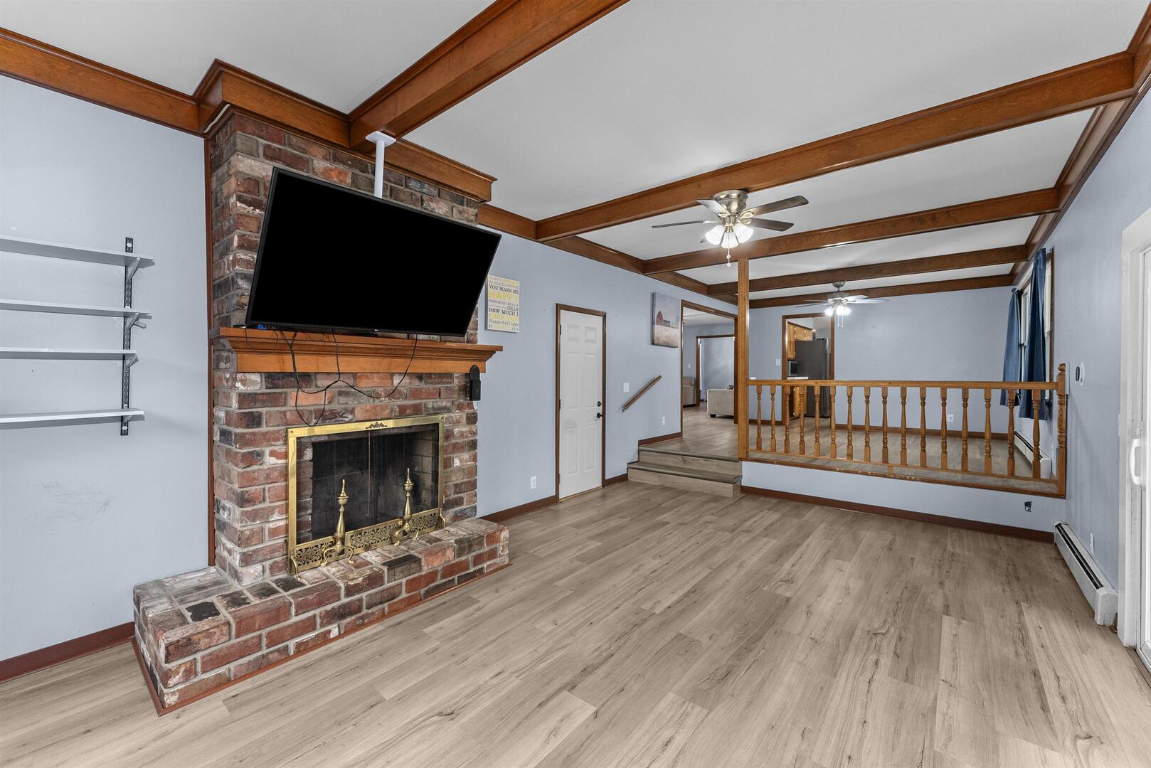 305 North Henderson Road Alexis, IL 61412 - Photo 14 of 31 a view of an empty room with wooden floor fireplace and a window