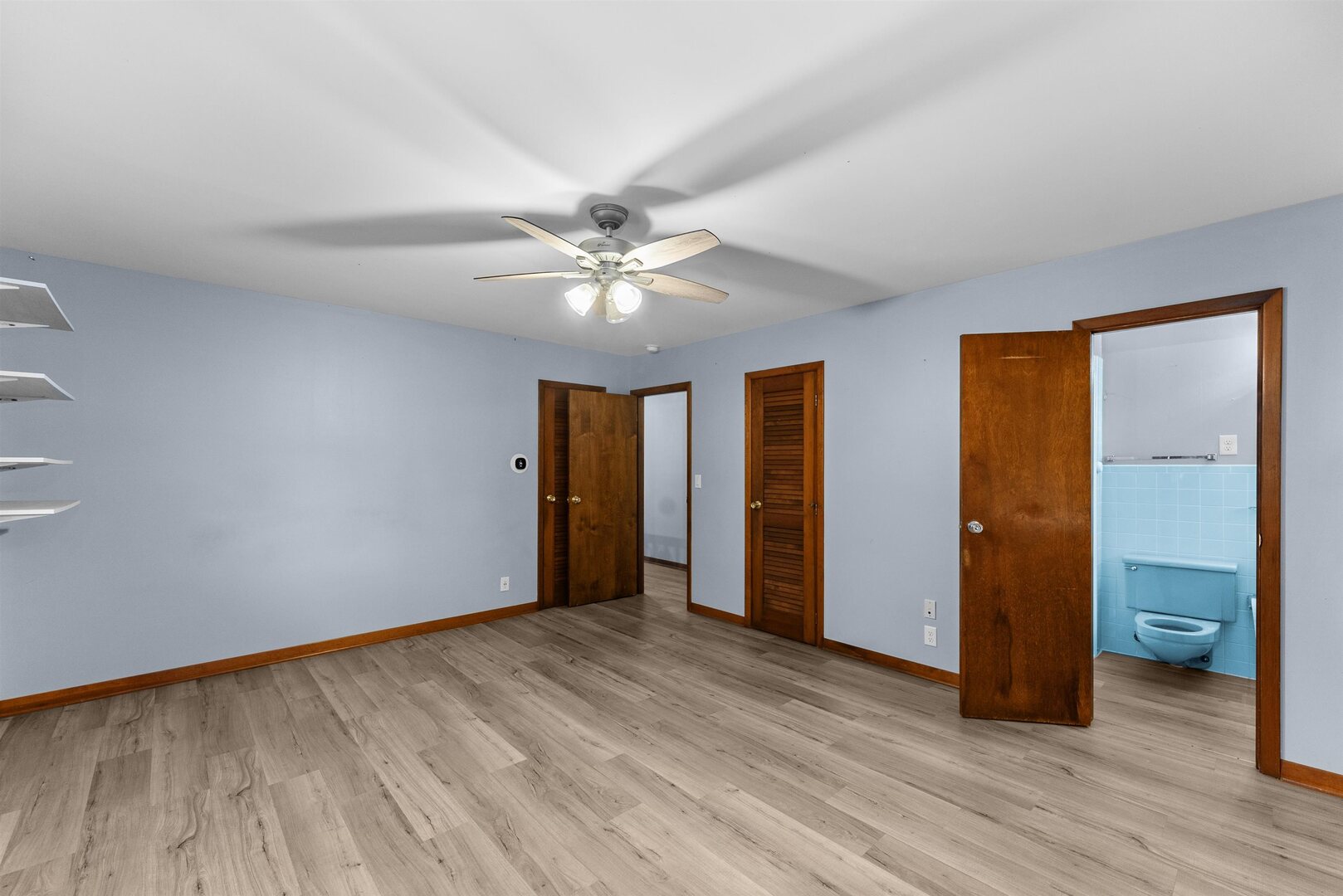305 North Henderson Road Alexis, IL 61412 - Photo 22 of 31 an empty room with wooden floor and a ceiling fan