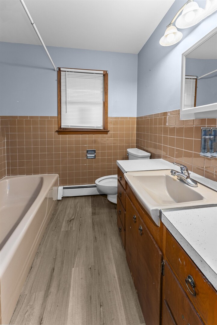 305 North Henderson Road Alexis, IL 61412 - Photo 25 of 31 a bathroom with a granite countertop sink a toilet and bathtub