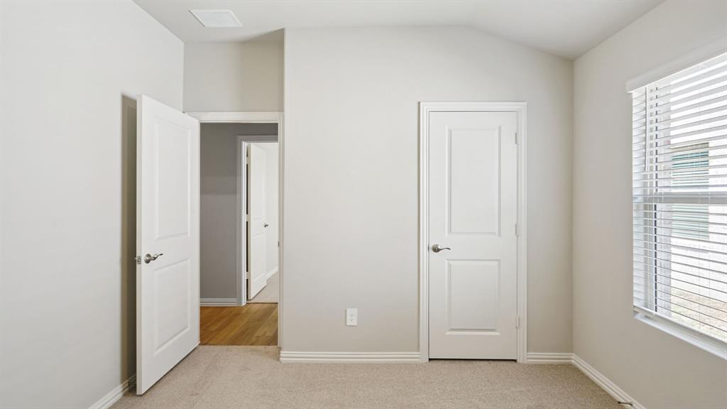 2215 Currents Road Princeton, TX 75407 - Photo 20 of 37 an empty room with windows and closet