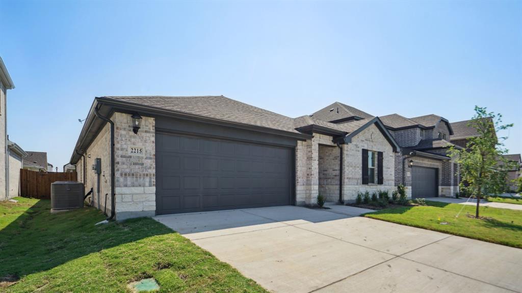 2215 Currents Road Princeton, TX 75407 - Photo 2 of 37 a front view of a house with a garden