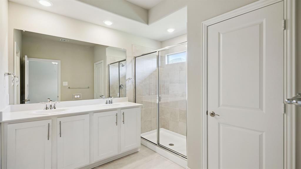2215 Currents Road Princeton, TX 75407 - Photo 30 of 37 a bathroom with a double vanity sink mirror and double